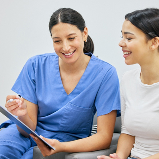 Dental team member discussing cost with female patient
