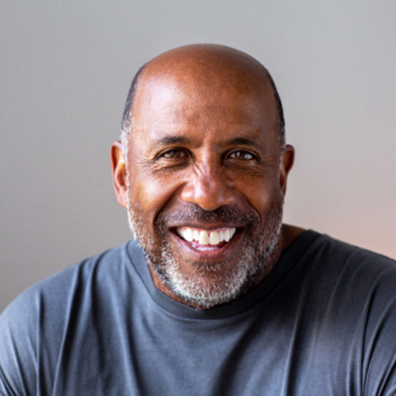Senior man smiling in gray shirt