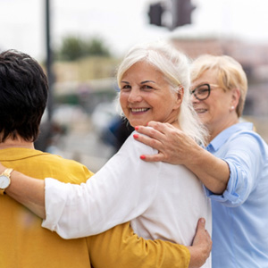 Group of women smiling while walking together outside